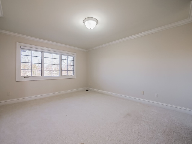 carpeted spare room featuring crown molding