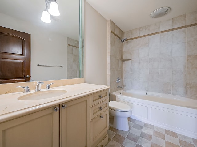 full bathroom with vanity, tiled shower / bath combo, and toilet