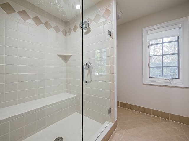 bathroom featuring tile patterned flooring and an enclosed shower