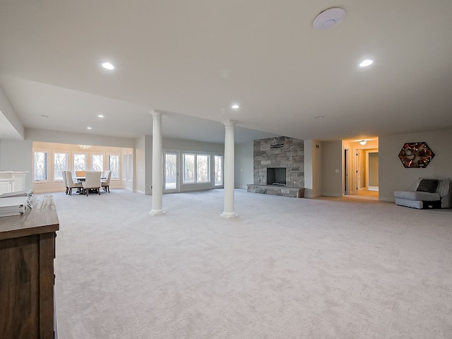 unfurnished living room featuring light carpet and a fireplace