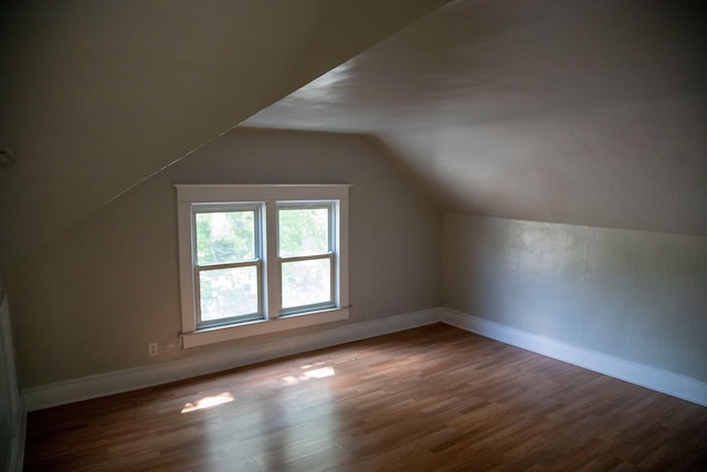 additional living space featuring hardwood / wood-style floors and vaulted ceiling