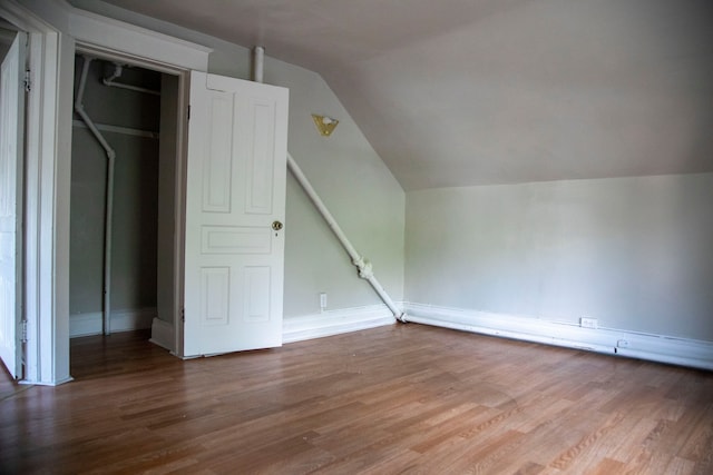 bonus room featuring wood-type flooring and vaulted ceiling