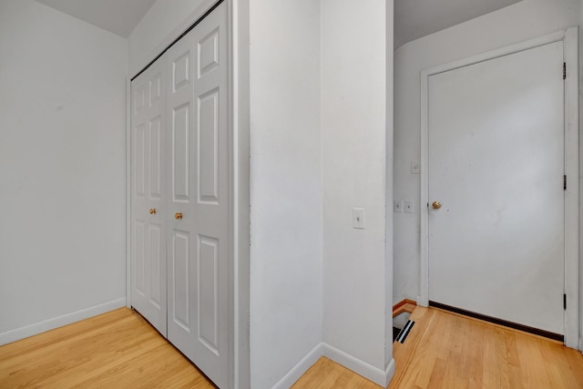 corridor with light hardwood / wood-style flooring