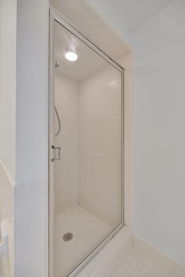 bathroom with tile patterned floors and walk in shower