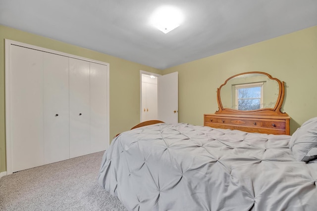 bedroom featuring light colored carpet and a closet