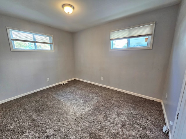 carpeted spare room with plenty of natural light