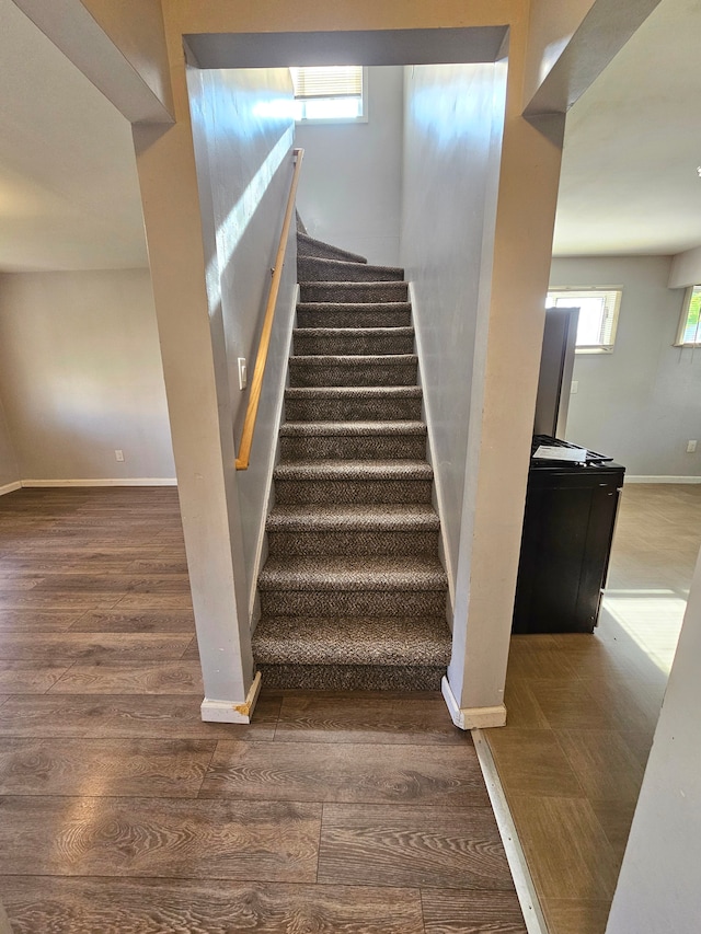 stairs with hardwood / wood-style floors