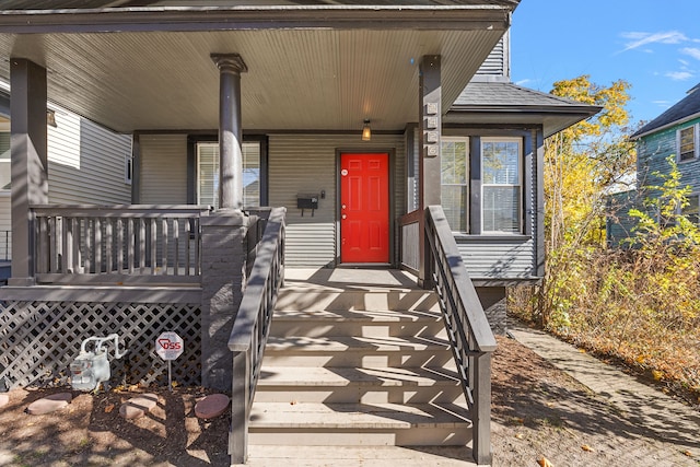 view of exterior entry with covered porch