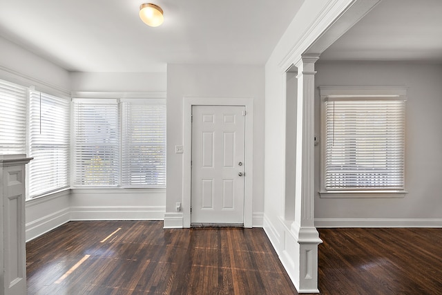 entrance foyer with dark hardwood / wood-style floors and decorative columns