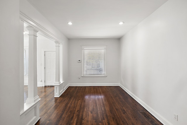 empty room featuring dark hardwood / wood-style flooring