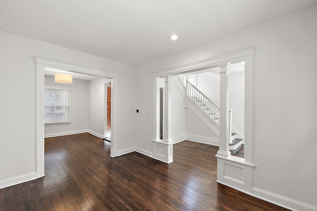 unfurnished room with dark hardwood / wood-style flooring