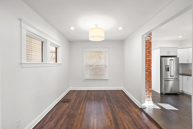 unfurnished dining area with dark hardwood / wood-style flooring