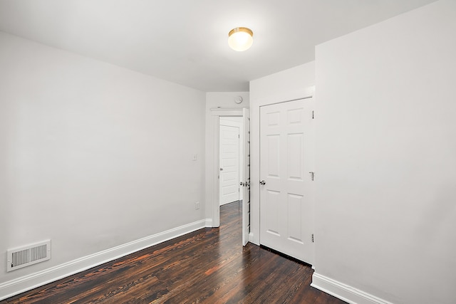 unfurnished room featuring dark hardwood / wood-style floors