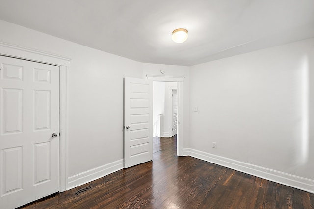 unfurnished bedroom featuring dark hardwood / wood-style floors