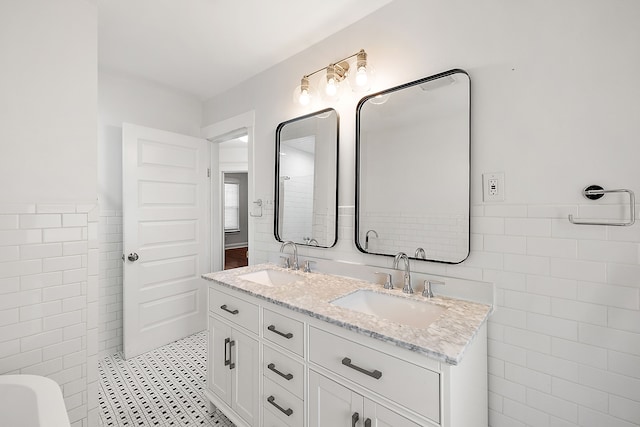 bathroom with tile patterned flooring, vanity, and tile walls