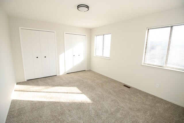 40831 Highpointe Dr, Clinton Township, MI 48038 - unfurnished bedroom featuring multiple closets, carpet, and baseboards