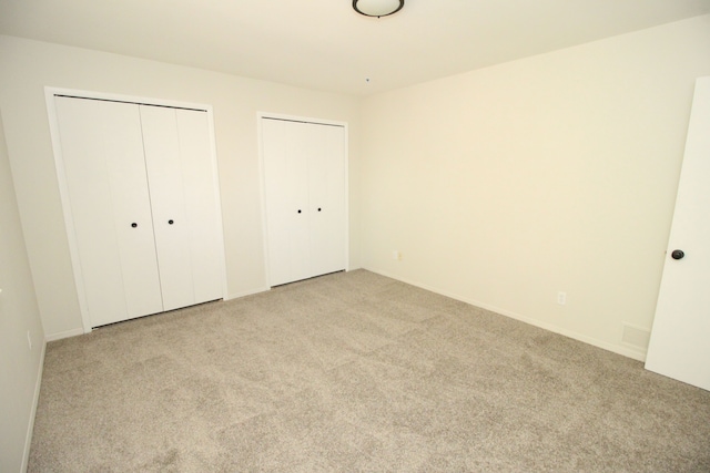40831 Highpointe Dr, Clinton Township, MI 48038 - unfurnished bedroom with two closets, light colored carpet, and baseboards