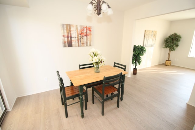 40831 Highpointe Dr, Clinton Township, MI 48038 - dining area with light wood-style flooring, a chandelier, and baseboards