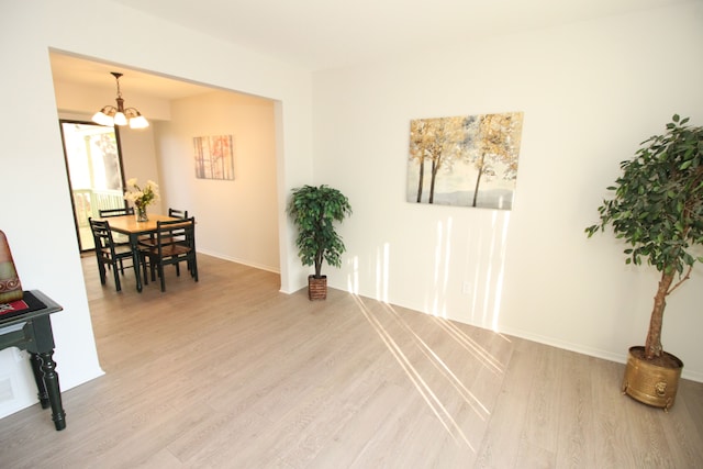 40831 Highpointe Dr, Clinton Township, MI 48038 - dining space with light wood-style flooring, a chandelier, and baseboards