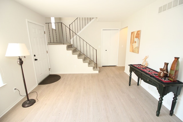 40831 Highpointe Dr, Clinton Township, MI 48038 - foyer entrance featuring light wood finished floors, stairway, and baseboards