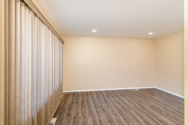 empty room with dark hardwood / wood-style flooring