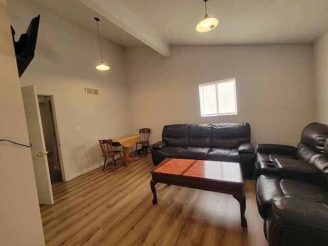 living room with beam ceiling, high vaulted ceiling, and light hardwood / wood-style flooring