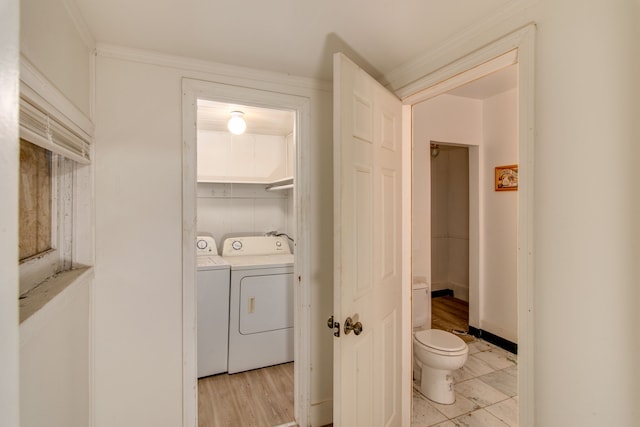 laundry room featuring light wood-type flooring, independent washer and dryer, and ornamental molding