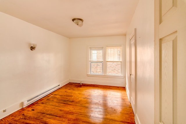 unfurnished room with light hardwood / wood-style flooring and a baseboard radiator