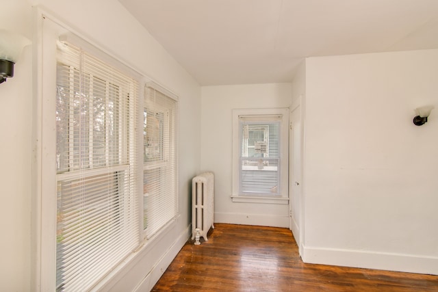 corridor featuring dark hardwood / wood-style floors and radiator