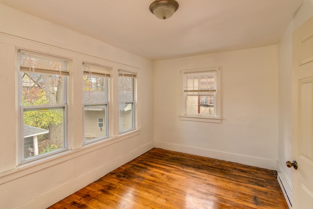 unfurnished room with dark wood-type flooring