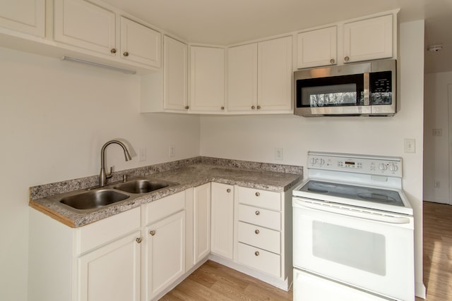 kitchen with light hardwood / wood-style floors, white cabinetry, white electric range, and sink