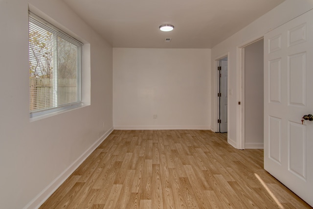 unfurnished room with light wood-type flooring