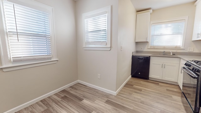 kitchen with backsplash, white cabinets, stainless steel stove, light hardwood / wood-style flooring, and black dishwasher