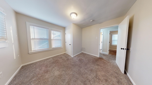 unfurnished bedroom with light carpet