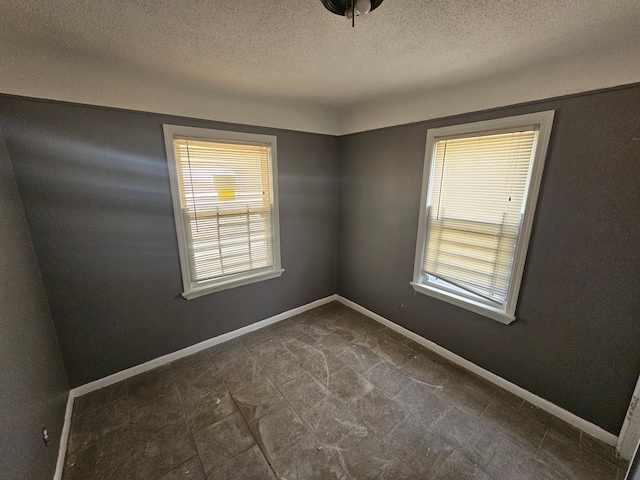 empty room with a textured ceiling