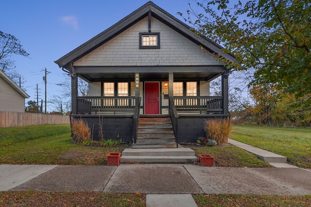 bungalow-style home with a porch and a front lawn