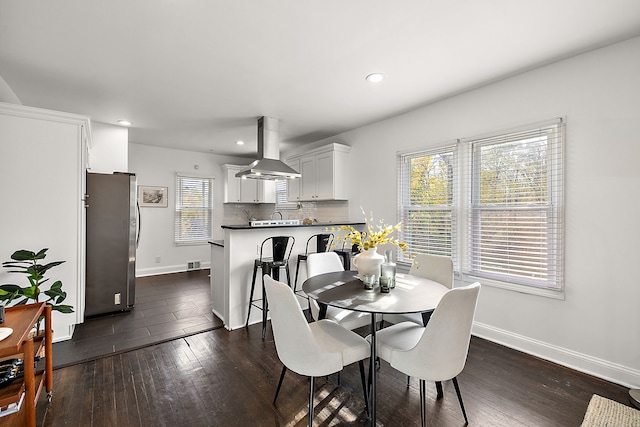 dining space featuring dark hardwood / wood-style flooring and a wealth of natural light