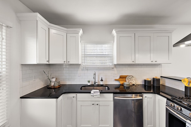 kitchen with decorative backsplash, white cabinetry, sink, and stainless steel appliances