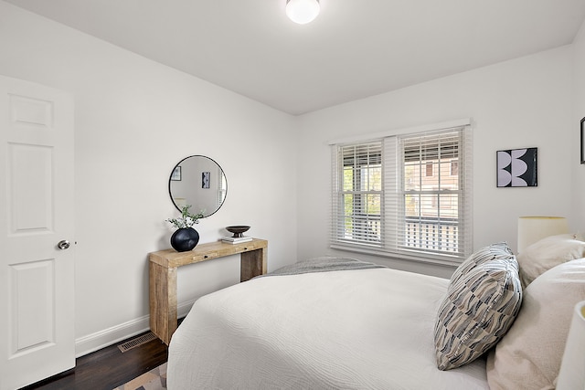 bedroom with dark wood-type flooring