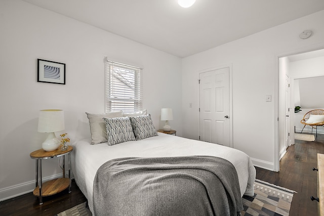 bedroom with dark hardwood / wood-style flooring