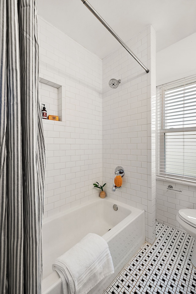 bathroom with toilet, tile patterned floors, and shower / bathtub combination with curtain