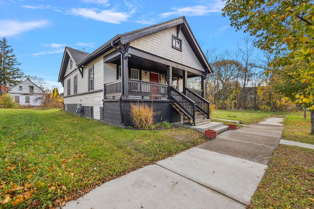 bungalow-style home with covered porch and a front yard