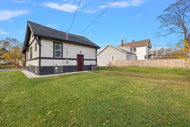 back of house with a lawn