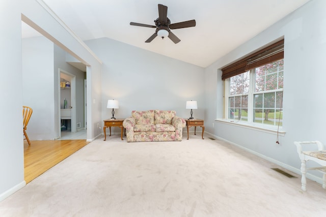 living room featuring carpet, vaulted ceiling, and ceiling fan