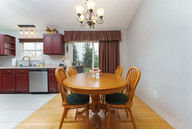 dining area featuring a notable chandelier, plenty of natural light, and light tile patterned floors