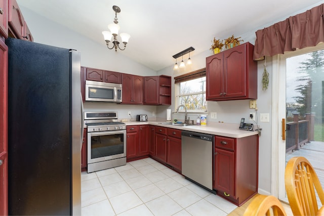 kitchen featuring an inviting chandelier, sink, vaulted ceiling, decorative light fixtures, and stainless steel appliances