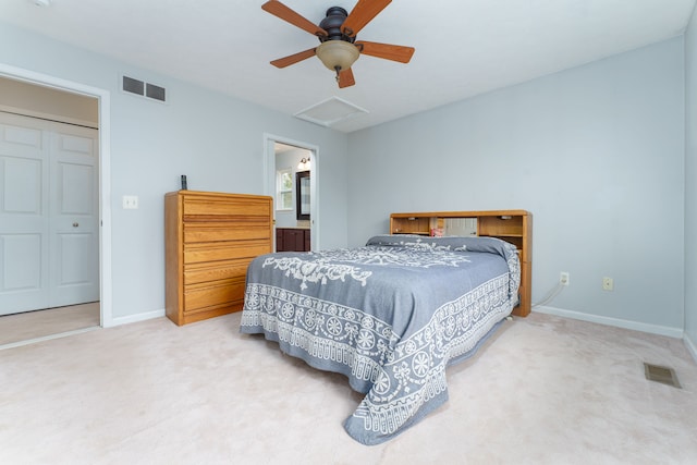 carpeted bedroom with a closet, ceiling fan, and ensuite bathroom