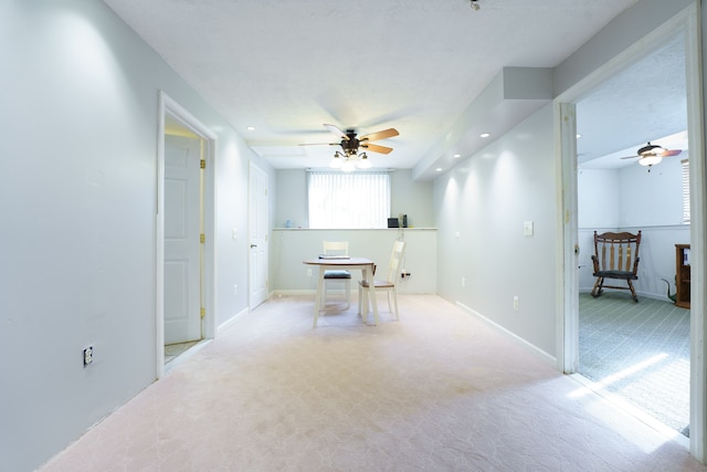 dining space with light carpet and ceiling fan