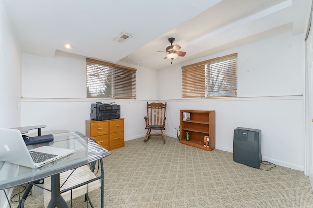 carpeted office space with ceiling fan