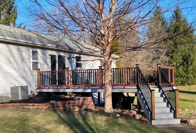 deck featuring a lawn and central air condition unit